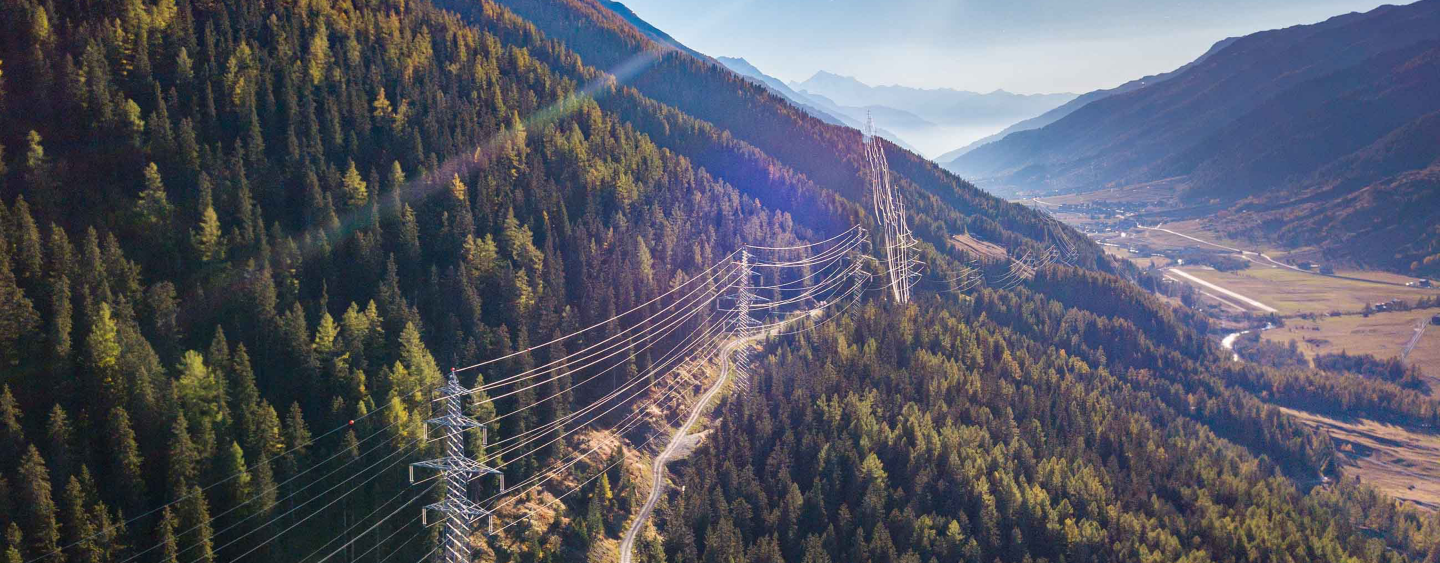 Aerial view of power line pylon in mountaineous area in Switzerland, Europe