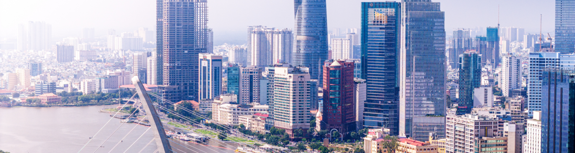 Aerial view of Ho Chi Minh city skyline with buildings, roads, bridge and Saigon river in Vietnam in the morning. Travel and business concept.