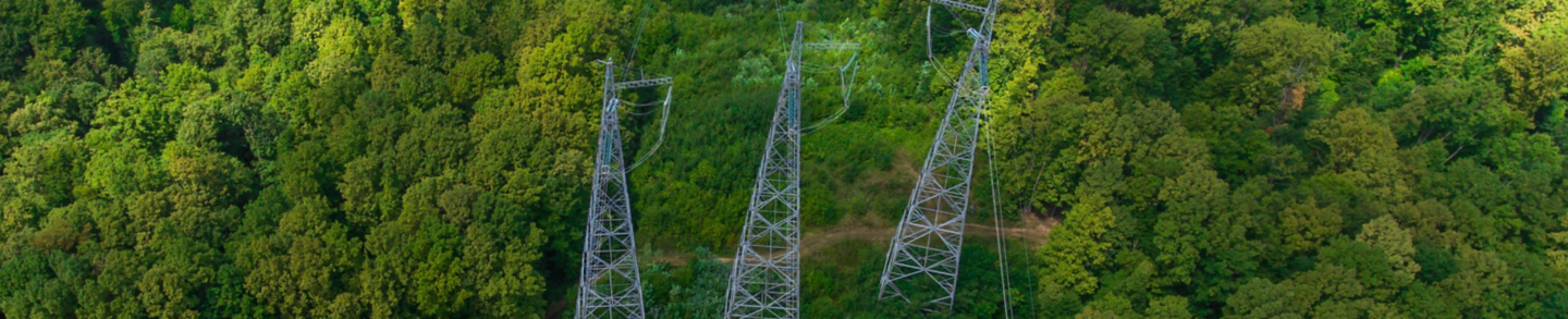 Aerial view. High voltage metal post. High-voltage towers in the forest.