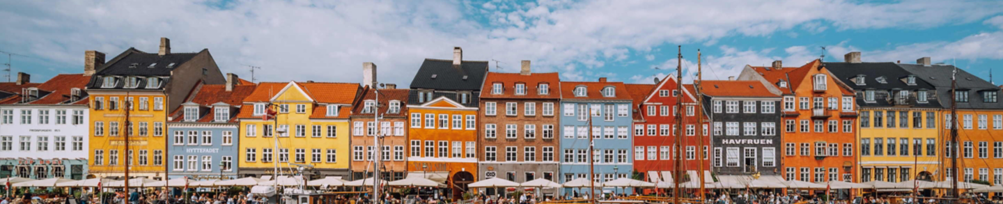 COPENHAGEN, DENMARK, SEPTEMBER 17, 2021: Copenhagen iconic view. Famous old Nyhavn port in the center of Copenhagen, Denmark during winter sunny day