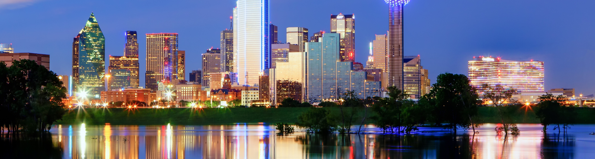 Downtown Dallas Texas reflects on the full Trinity River.