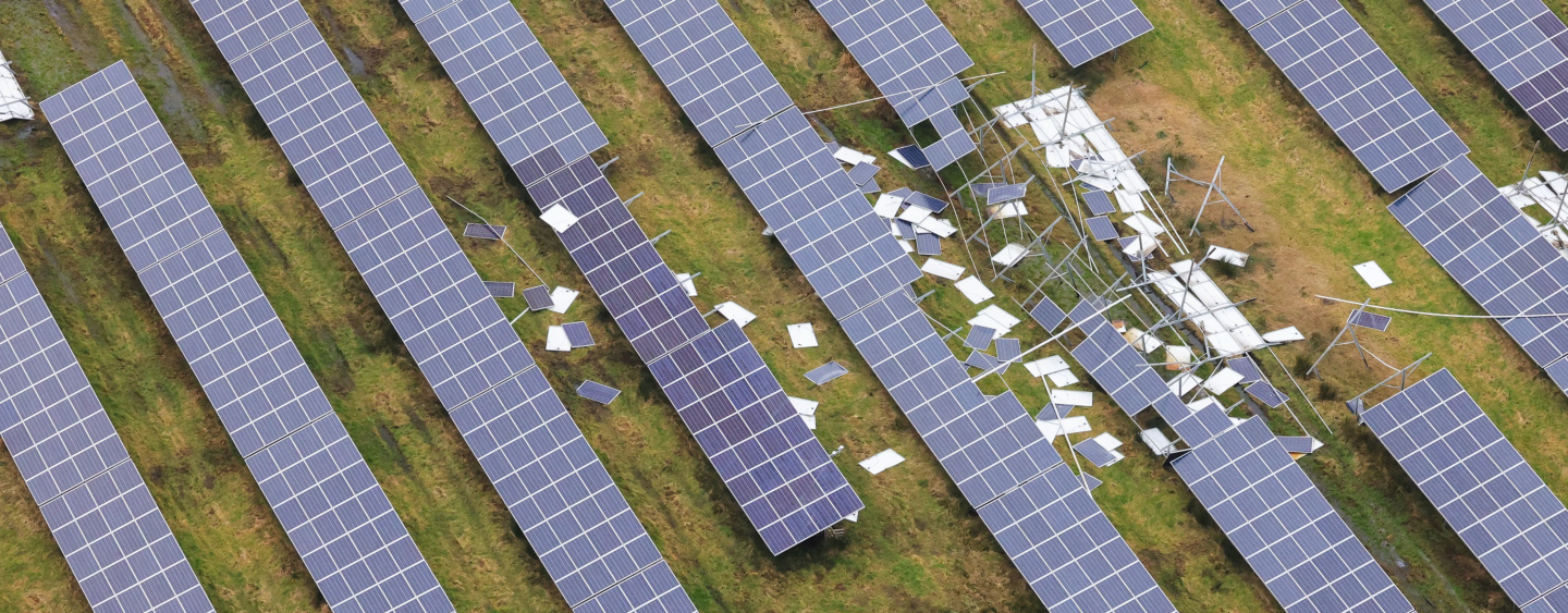 An aerial view taken from a helicopter of a damaged solar farm in Britain. Stormy weather and strong winds have broken and destroyed solar panels. Photovoltaic panels scattered across a field. 