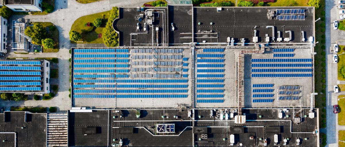 Aerial view of solar panels installed on factory rooftop