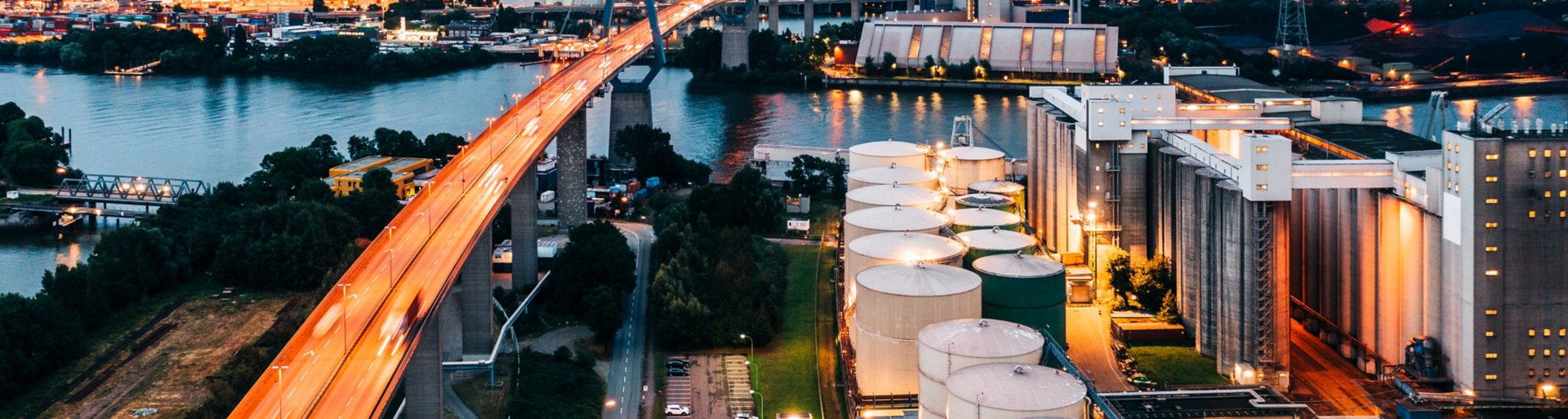 An illuminated power station, flyover and Hamburg docks