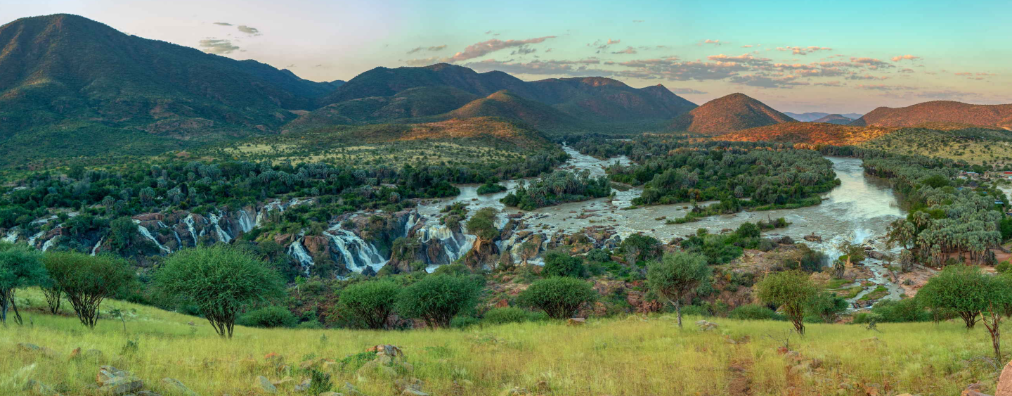 Epupa Falls full of water on the Kunene River, Northern Namibia and Angola border. Sunrise african landscape. Pure nature