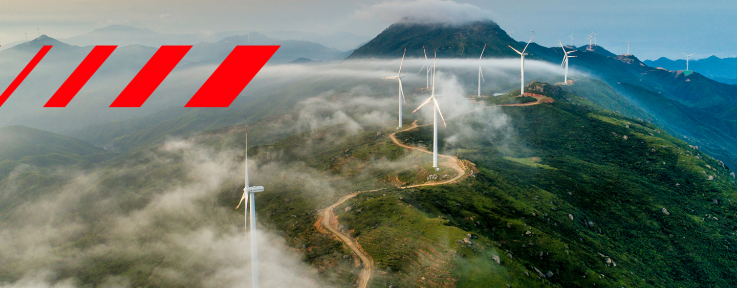 Hitachi Energy signature red pattern on mountain with wind turbines