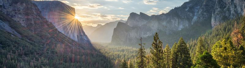 mountains with clouds and sunrise depicting a sustainable future