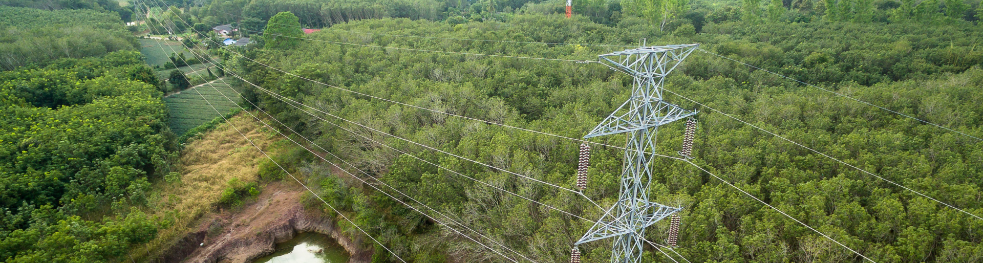 Aerial view of High voltage post or High voltage tower in forest