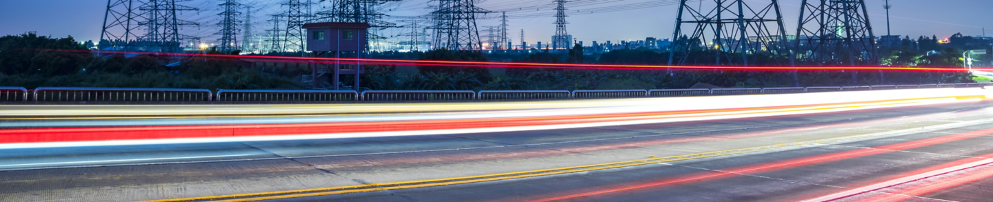 High voltage, high speed road car track in the background of high voltage towers