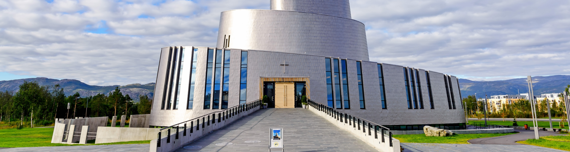 Alta, Norway - August 16, 2016: View of the main entrance side of the Northern Lights Cathedral. This modern church was built in a circular style in 2013