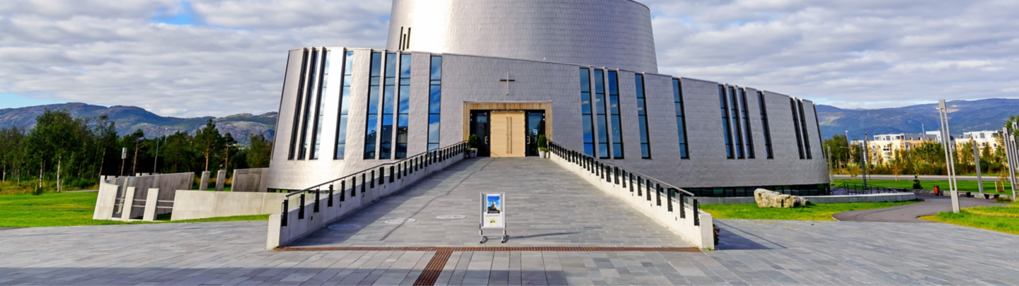 Alta, Norway - August 16, 2016: View of the main entrance side of the Northern Lights Cathedral. This modern church was built in a circular style in 2013